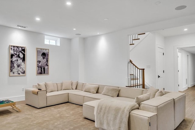 living room featuring stairs, recessed lighting, visible vents, and light wood finished floors