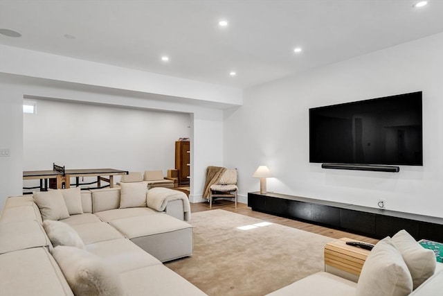 living room featuring recessed lighting, baseboards, and wood finished floors