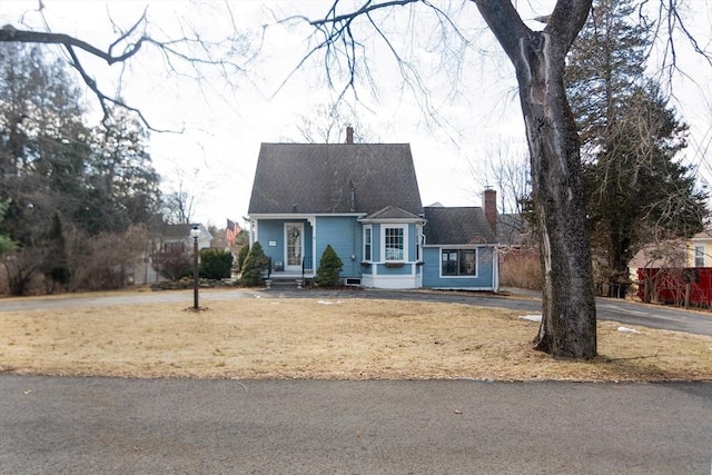 view of front of house featuring a chimney