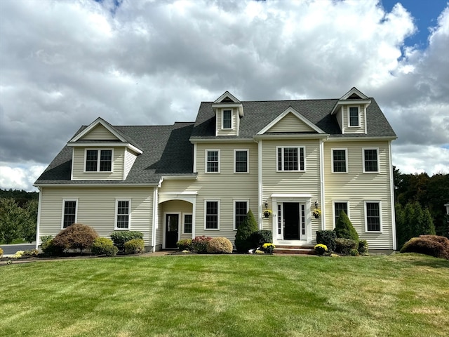 colonial-style house featuring a front yard