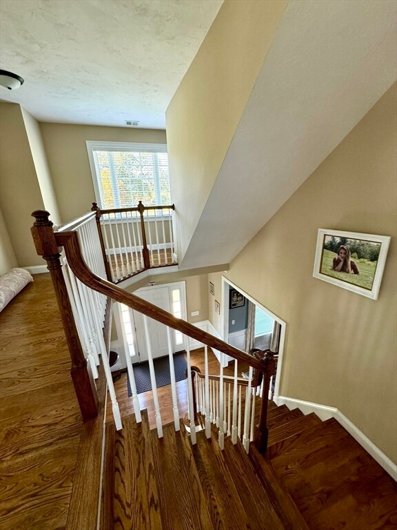 staircase with hardwood / wood-style flooring