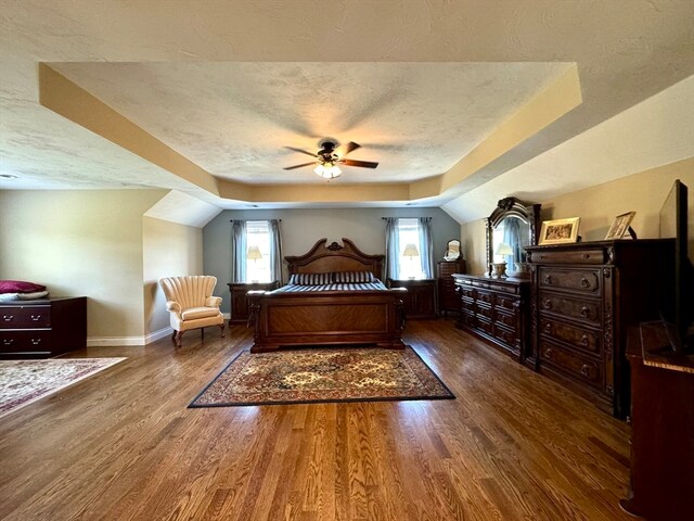 bedroom featuring a textured ceiling, ceiling fan, vaulted ceiling, and dark hardwood / wood-style flooring