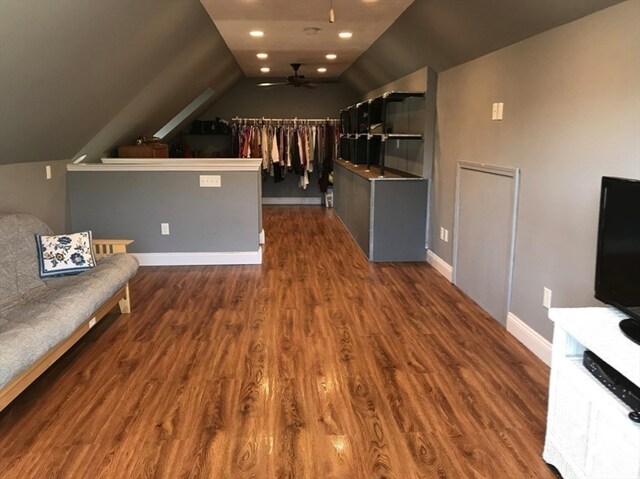 interior space featuring lofted ceiling, dark wood-type flooring, and ceiling fan