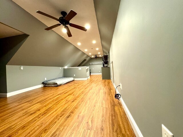 additional living space featuring light hardwood / wood-style flooring, vaulted ceiling, and ceiling fan