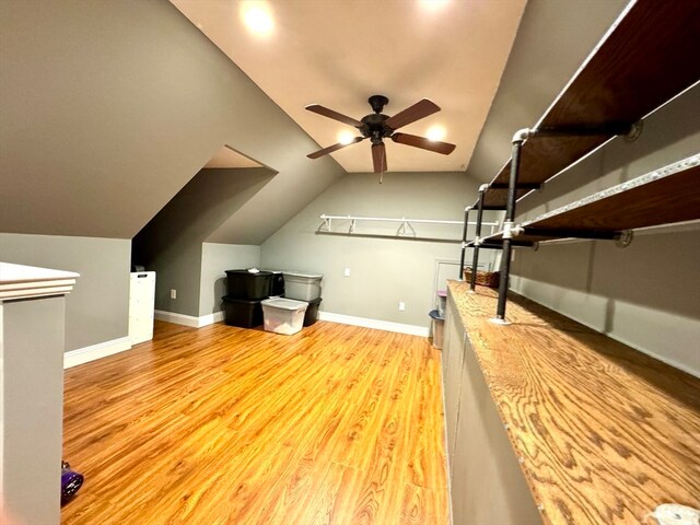 bonus room with light hardwood / wood-style flooring, lofted ceiling, and ceiling fan