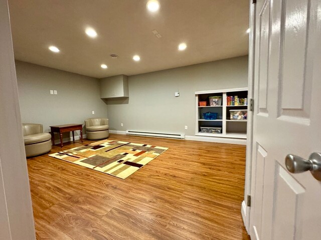 interior space with light hardwood / wood-style flooring and a baseboard heating unit