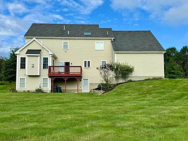 rear view of house featuring a lawn