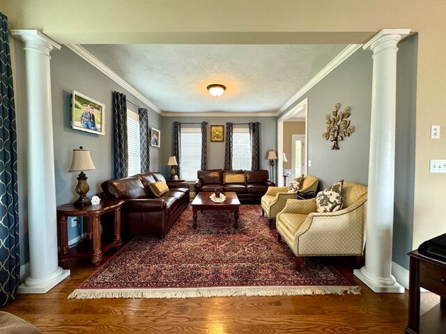 living room featuring a healthy amount of sunlight, ornamental molding, and hardwood / wood-style floors