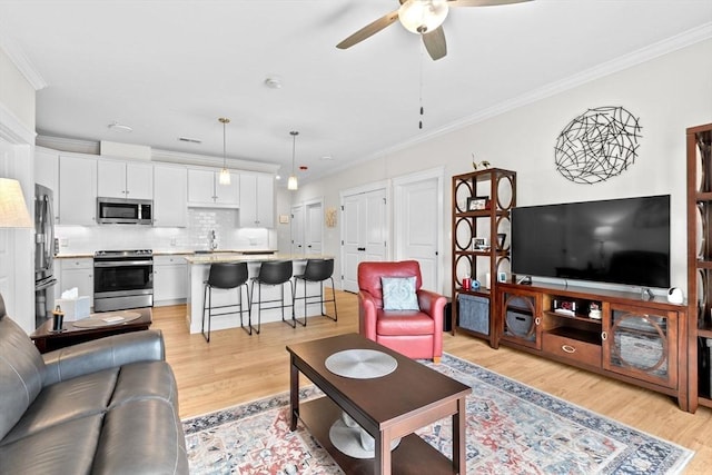 57 Long Point Rd Unit 110, Lakeville, MA 02347 - living area featuring ceiling fan, light wood finished floors, and crown molding