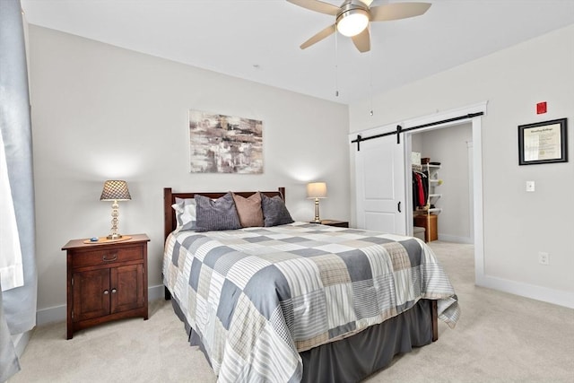 57 Long Point Rd Unit 110, Lakeville, MA 02347 - bedroom with a barn door, light carpet, a spacious closet, baseboards, and a closet
