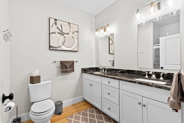 57 Long Point Rd Unit 110, Lakeville, MA 02347 - full bath with double vanity, a stall shower, toilet, wood finished floors, and baseboards