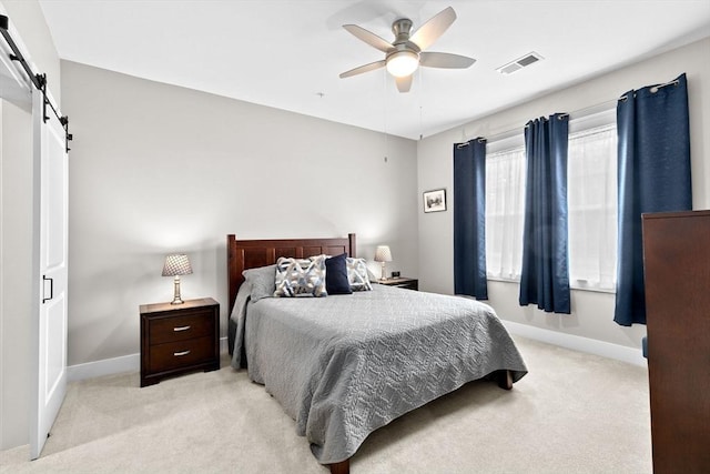 57 Long Point Rd Unit 110, Lakeville, MA 02347 - bedroom featuring a barn door, light carpet, baseboards, and ceiling fan