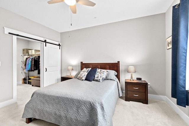 57 Long Point Rd Unit 110, Lakeville, MA 02347 - carpeted bedroom with a barn door, a walk in closet, baseboards, and a closet