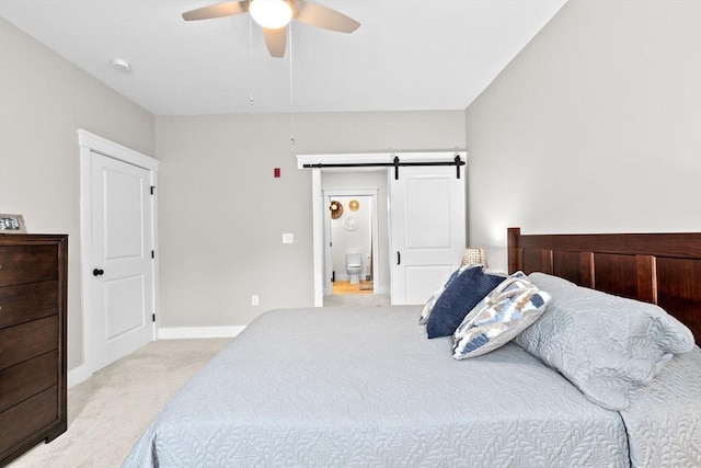 57 Long Point Rd Unit 110, Lakeville, MA 02347 - bedroom with light colored carpet, a barn door, baseboards, and ceiling fan