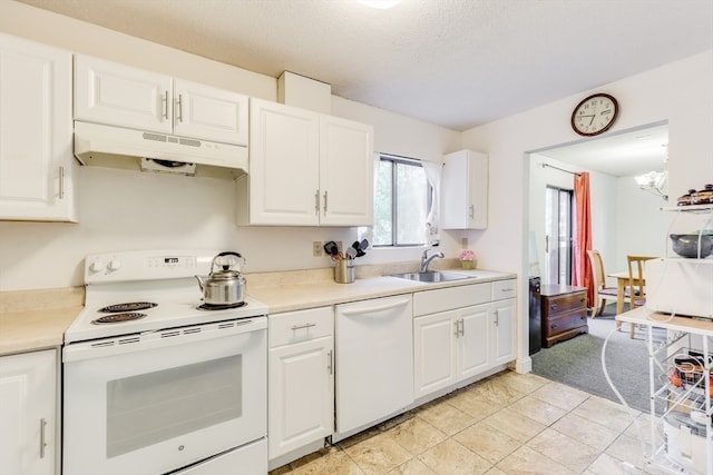 kitchen with white cabinetry, white appliances, light tile patterned floors, an inviting chandelier, and sink