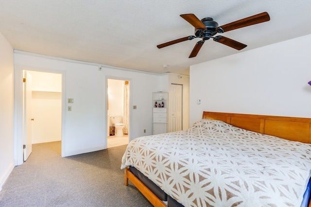 bedroom featuring a textured ceiling, ceiling fan, a closet, ensuite bathroom, and light colored carpet