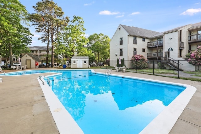 view of pool with an outdoor structure