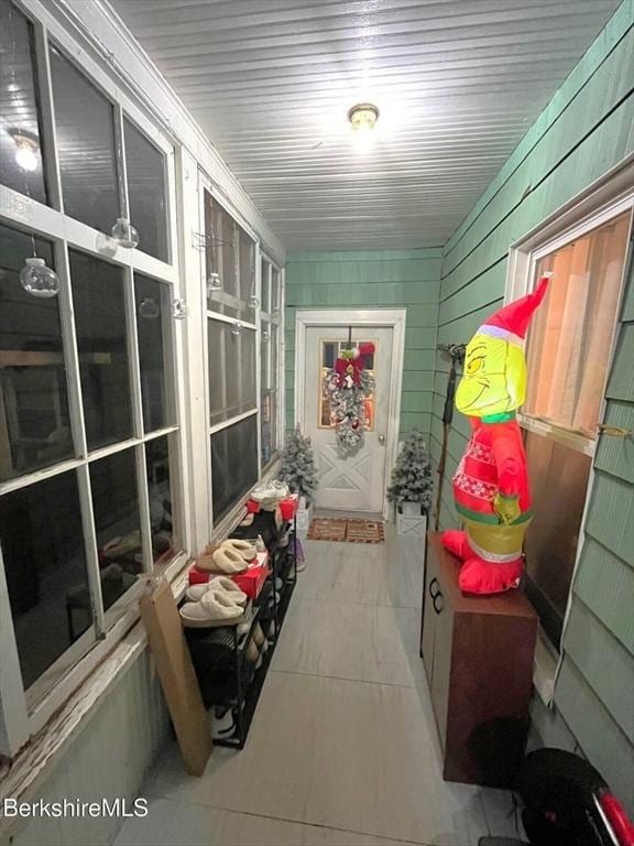 mudroom with wood walls