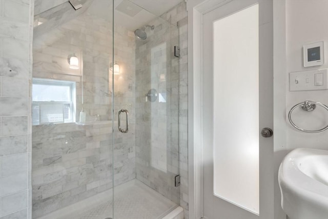 full bathroom featuring a stall shower and a sink