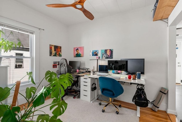office area featuring plenty of natural light, ceiling fan, and wood finished floors