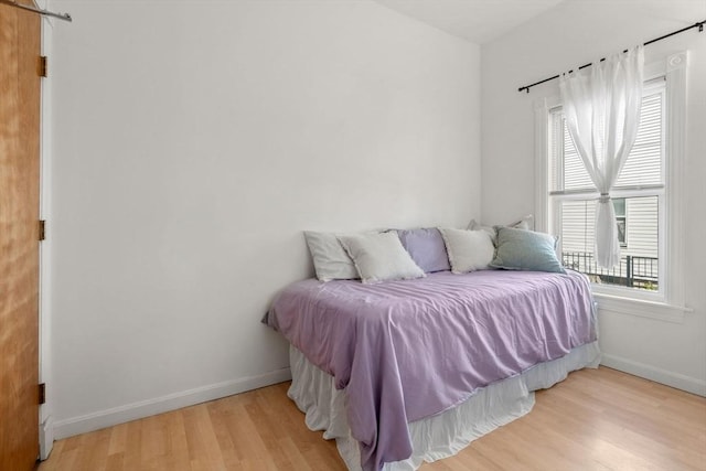 bedroom featuring wood finished floors and baseboards