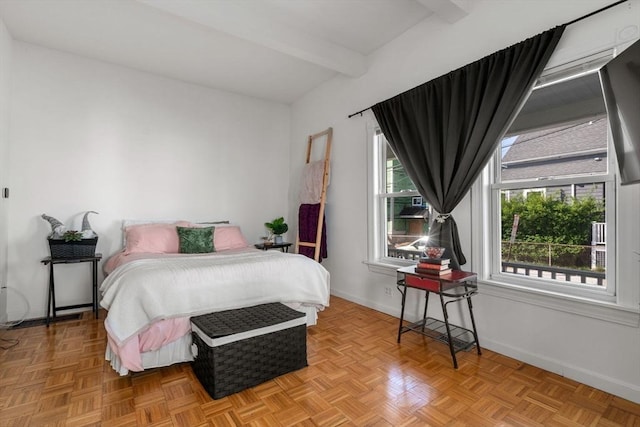 bedroom featuring beamed ceiling and baseboards