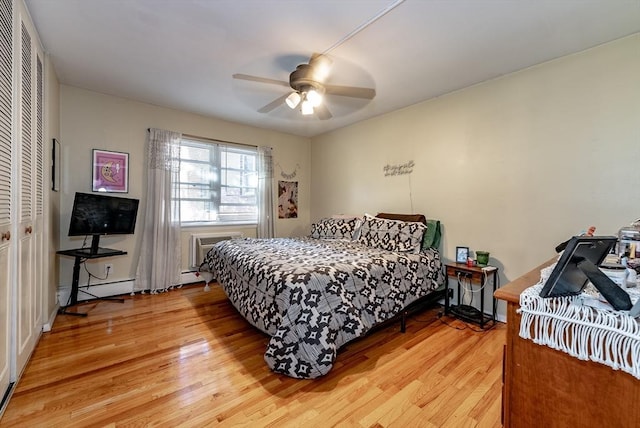 bedroom featuring a ceiling fan, light wood-style floors, a closet, and a baseboard radiator