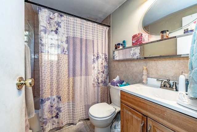 full bath with tile patterned floors, toilet, tile walls, shower / tub combo, and vanity