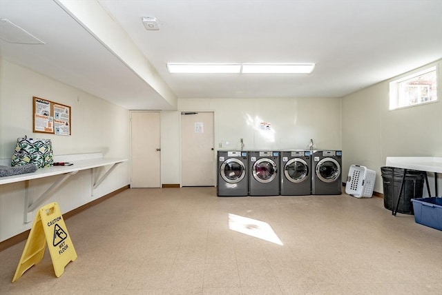 community laundry room featuring washer and clothes dryer and tile patterned floors