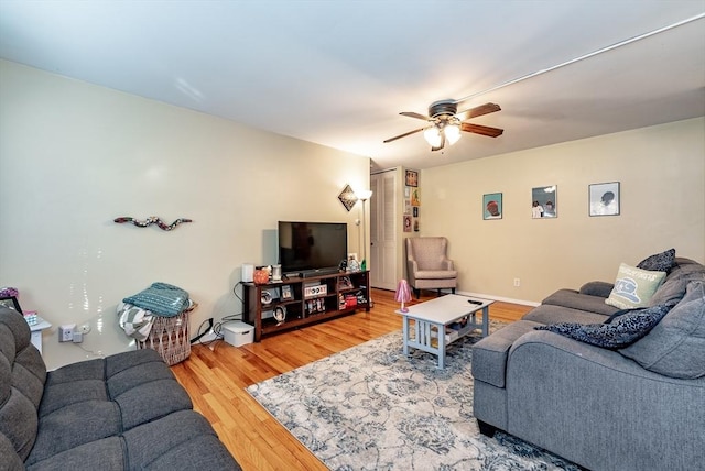 living area featuring ceiling fan and wood finished floors