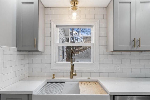 kitchen with gray cabinets and decorative backsplash