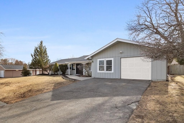 single story home with driveway and a garage