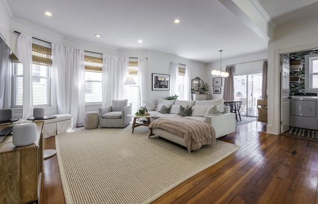 living area featuring washer / dryer, ornamental molding, dark wood-type flooring, a chandelier, and recessed lighting