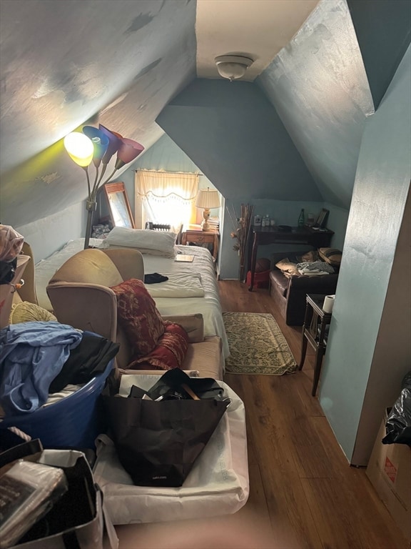 bedroom featuring lofted ceiling and wood-type flooring