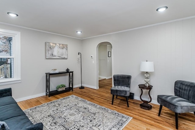 living room featuring hardwood / wood-style flooring and ornamental molding