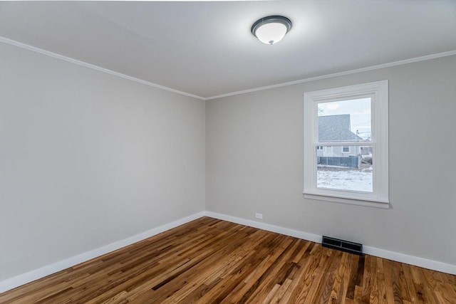 unfurnished room featuring hardwood / wood-style flooring and crown molding