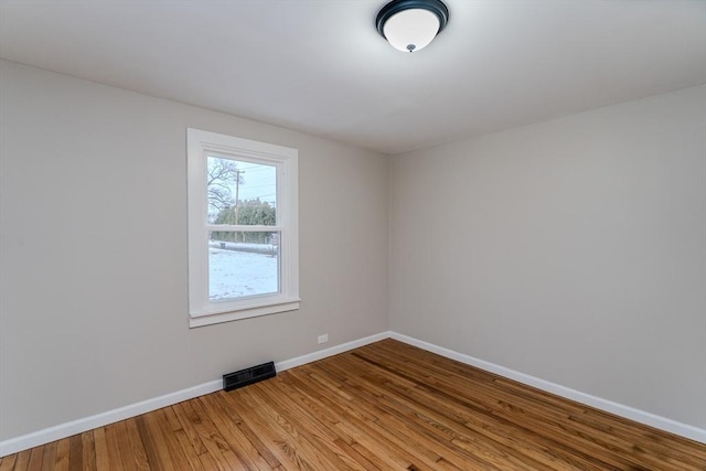 empty room with hardwood / wood-style flooring