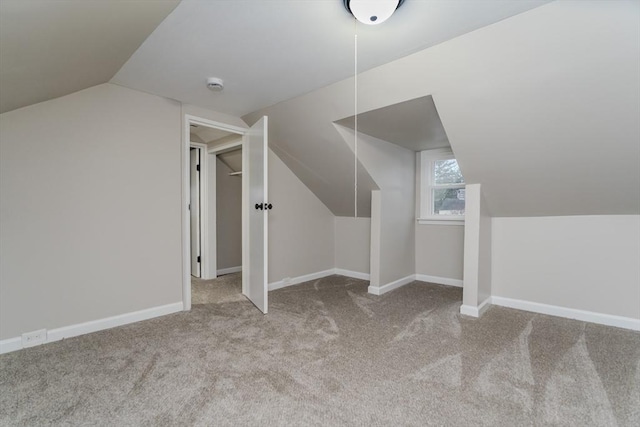 bonus room featuring light colored carpet and lofted ceiling