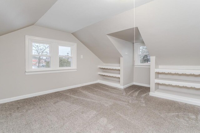 additional living space with lofted ceiling, carpet floors, and plenty of natural light