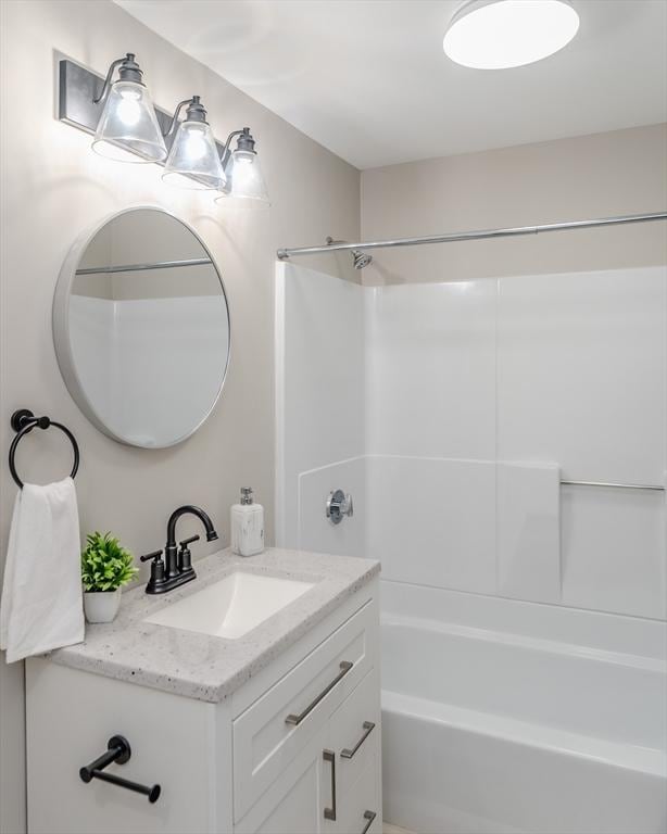 bathroom with vanity and shower / washtub combination