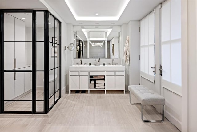 bathroom featuring vanity and a tray ceiling