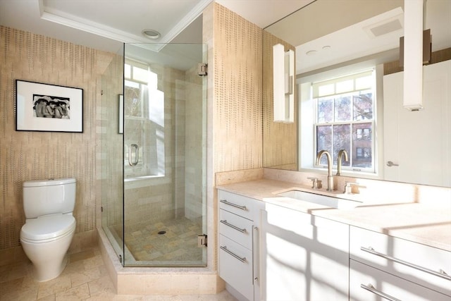 bathroom featuring vanity, toilet, ornamental molding, and walk in shower