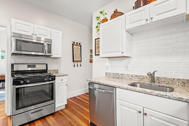 95 Child St Unit 2, Boston, MA 02130 - kitchen featuring appliances with stainless steel finishes, a sink, tasteful backsplash, and wood finished floors