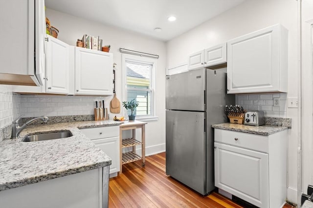 95 Child St Unit 2, Boston, MA 02130 - kitchen with freestanding refrigerator, a sink, white cabinets, decorative backsplash, and recessed lighting