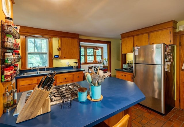 303 S St, Northampton, MA 01060 - kitchen with freestanding refrigerator, a sink, brown cabinetry, and plenty of natural light