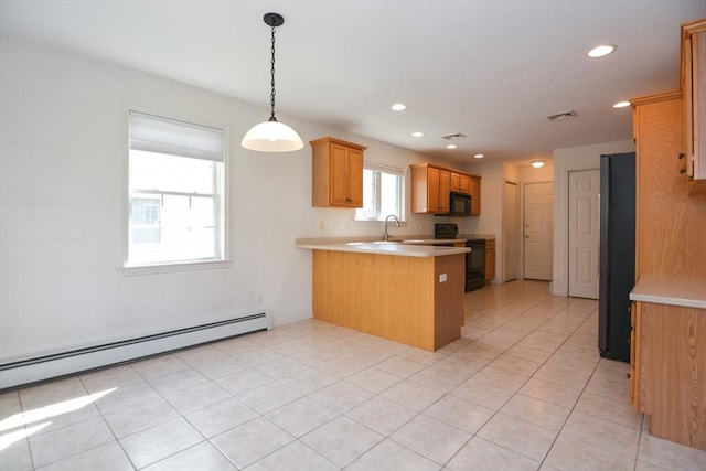 kitchen with light countertops, a peninsula, a baseboard heating unit, visible vents, and black appliances