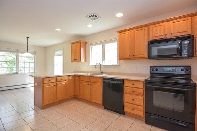 kitchen with a sink, light countertops, a peninsula, a baseboard radiator, and black appliances