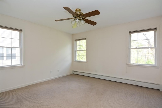 empty room with carpet floors, a baseboard radiator, baseboards, and ceiling fan