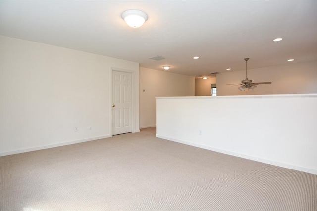 unfurnished room featuring recessed lighting, ceiling fan, light colored carpet, and baseboards
