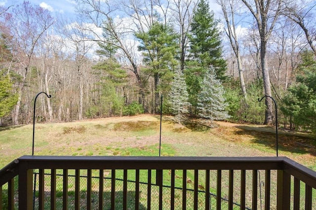 view of yard featuring fence and a balcony